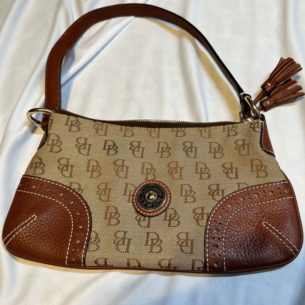 Dooney & Bourke NWOT satchel.  Classic Dooney style with leather handle/trim.
